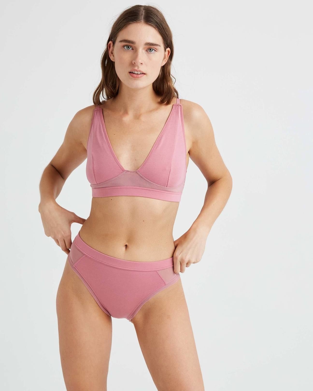 model wearing the briefs in pink with matching bralette