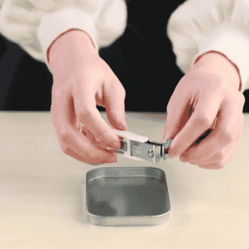 a model emptying the nail clippings into a tin