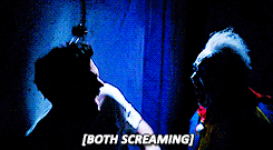 Nick screaming as a clown screams at him in a haunted house in New Girl