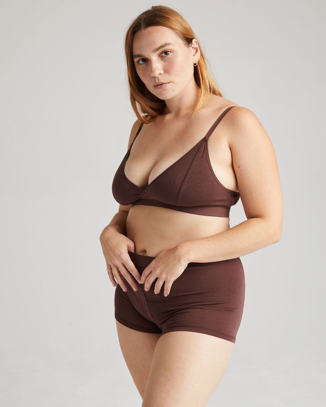 model wearing the boxer briefs in brown with a matching bralette