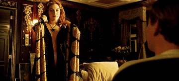 winslet beginning to disrobe in a scene from the movie