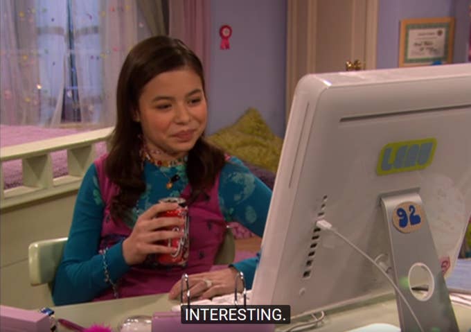 Megan looking at her desktop computer while holding a can of Coke