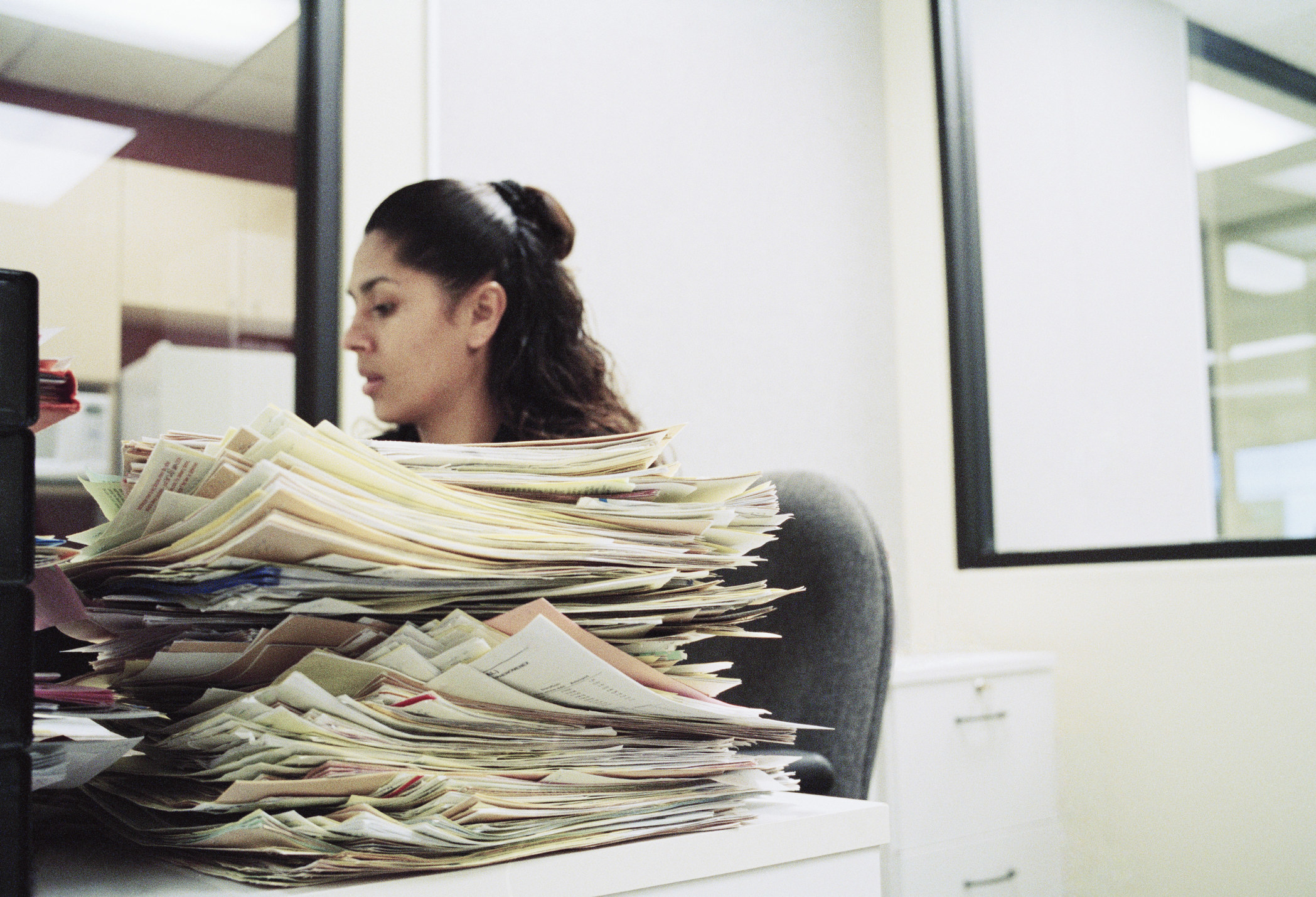 Woman with a pile of paperwork