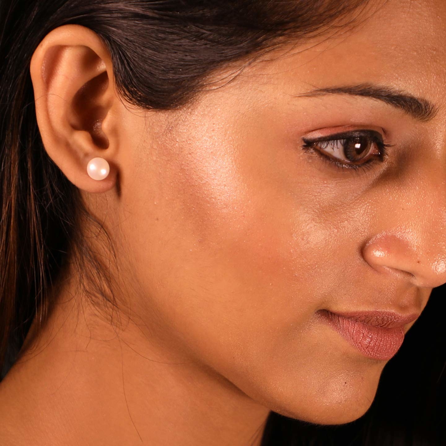 A woman wearing a pearl earring.