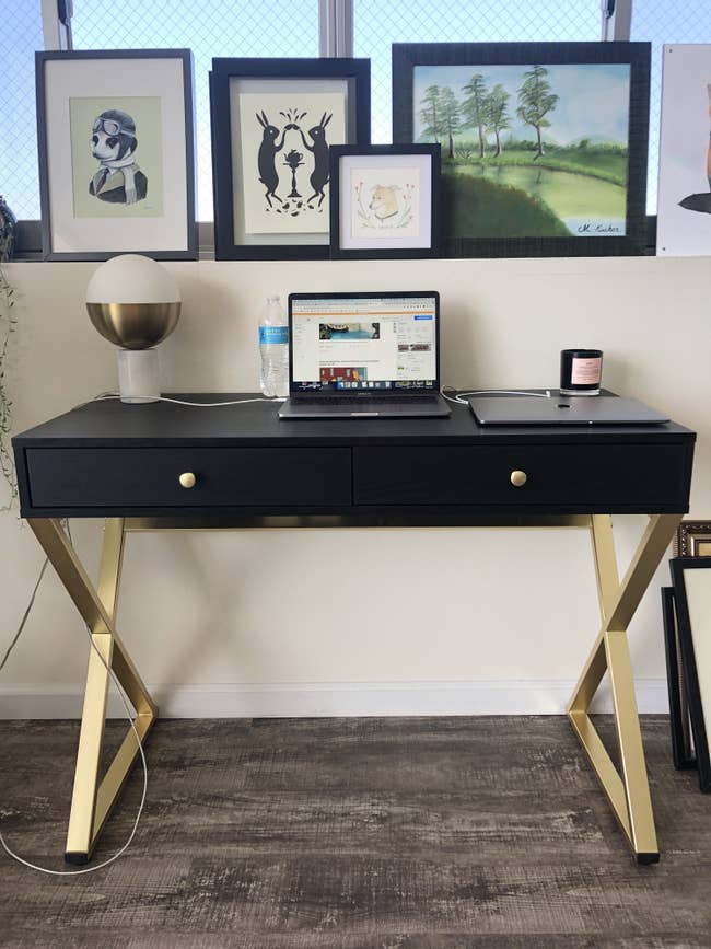 The desk is displayed against a wall