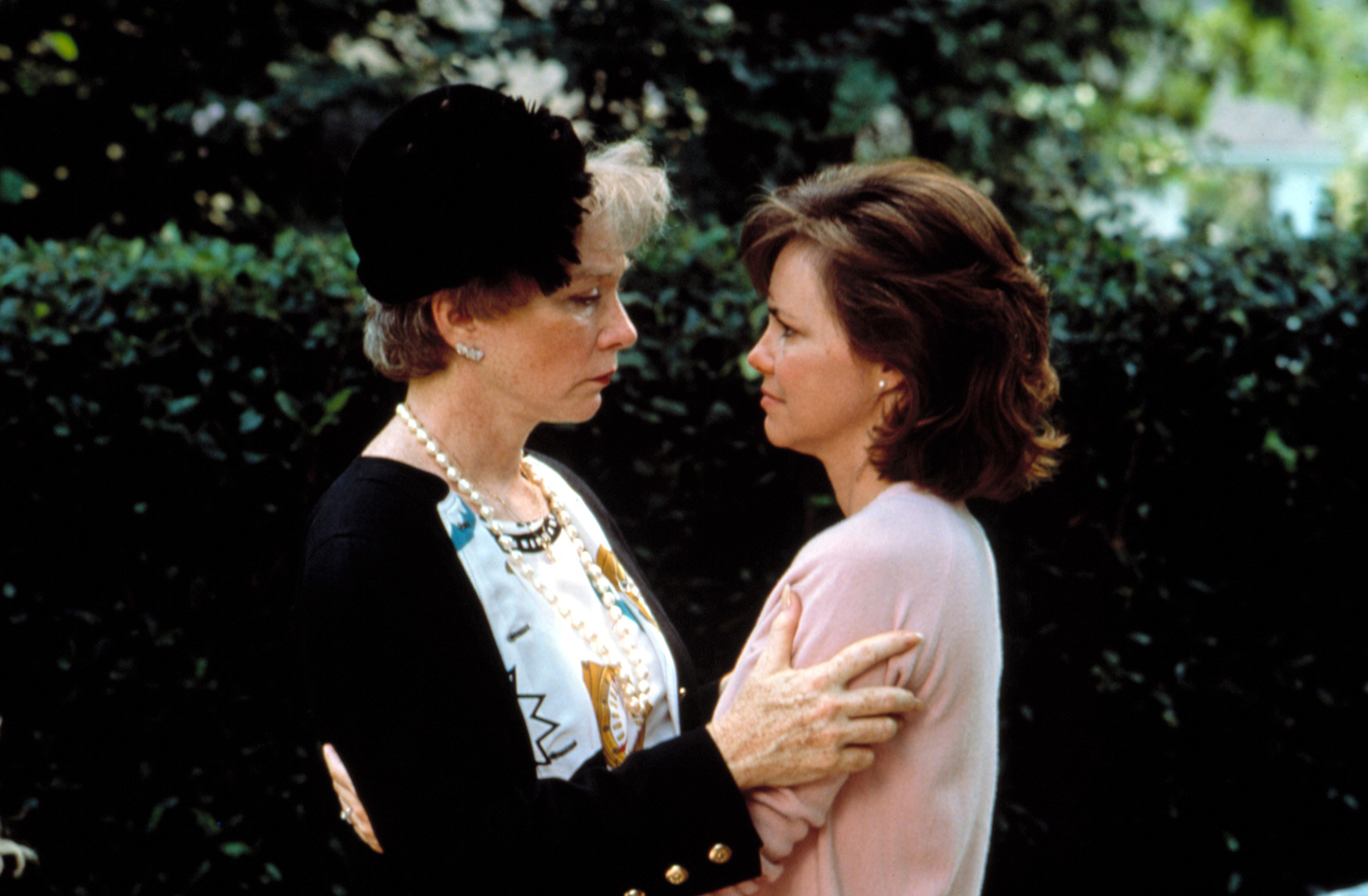 Shirley MacLaine and Sally Field embrace at a sad event