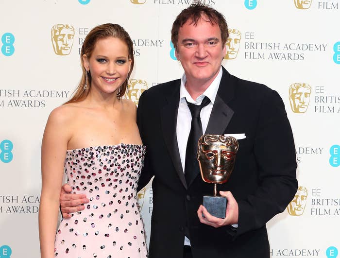 Jennifer poses with Quentin while he holds up an award