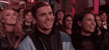 Zac Efron claps in the crowd while attending the MTV Movie and TV Awards