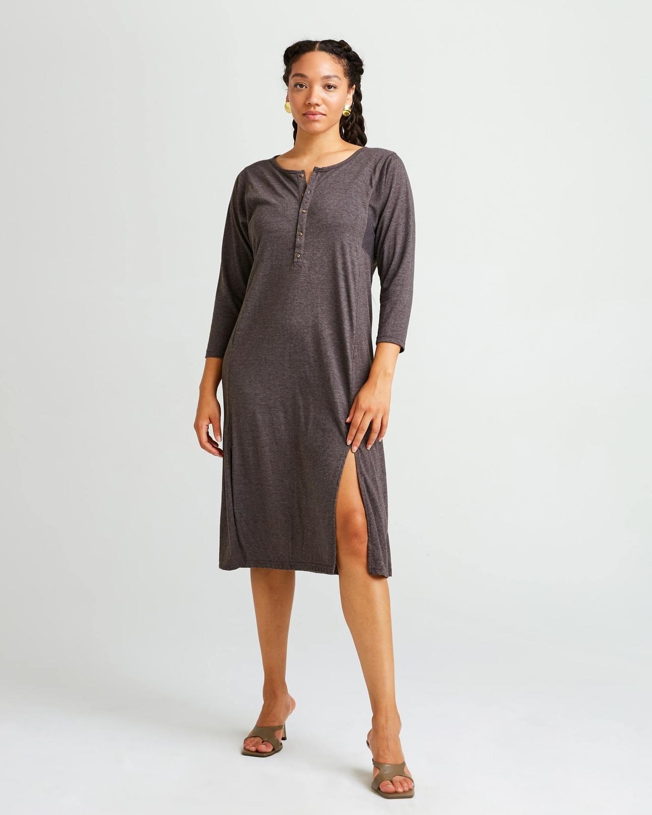 model wearing the brown dress with a slit in the thigh