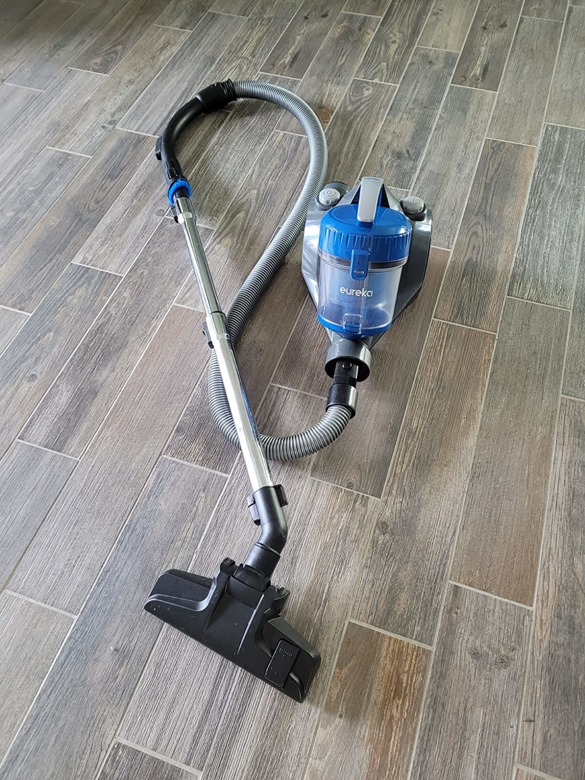 Blue and gray vacuum with metal and black accents