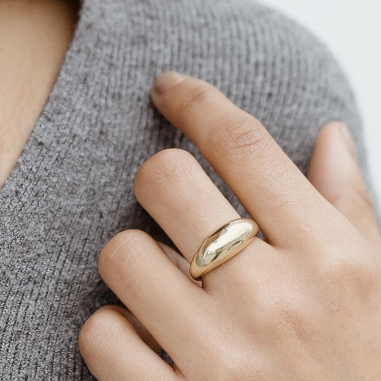 model wearing the gold bubble ring