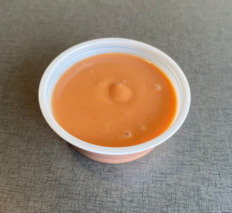White bowl of light orange sauce