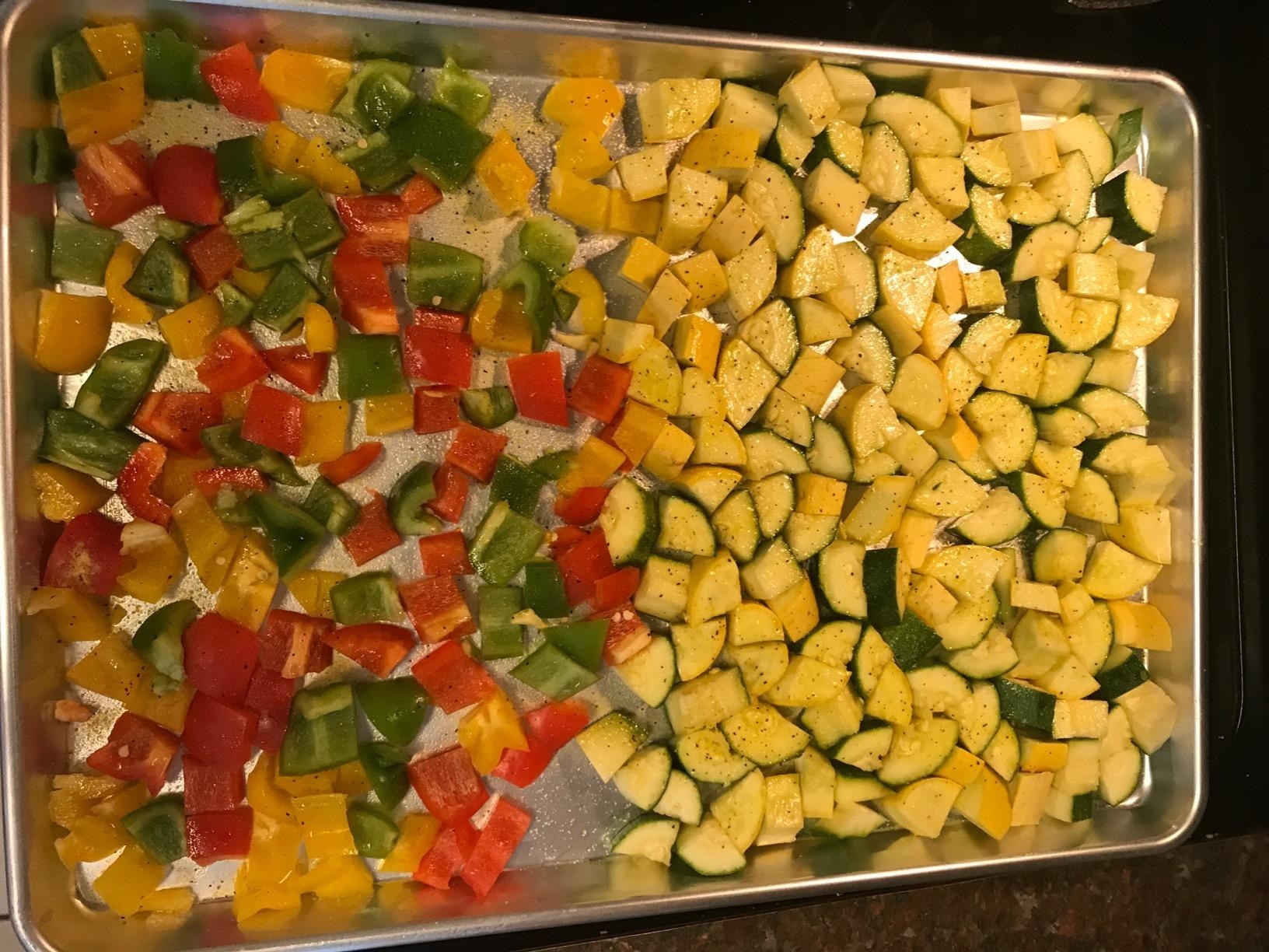 a reviewer photo of the baking sheet with peppers and zucchini on it