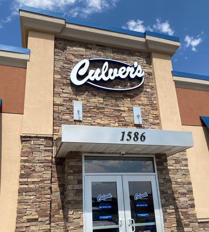 The outside entrance of a Culver's restaurant; it has a brick facade and a blue trim