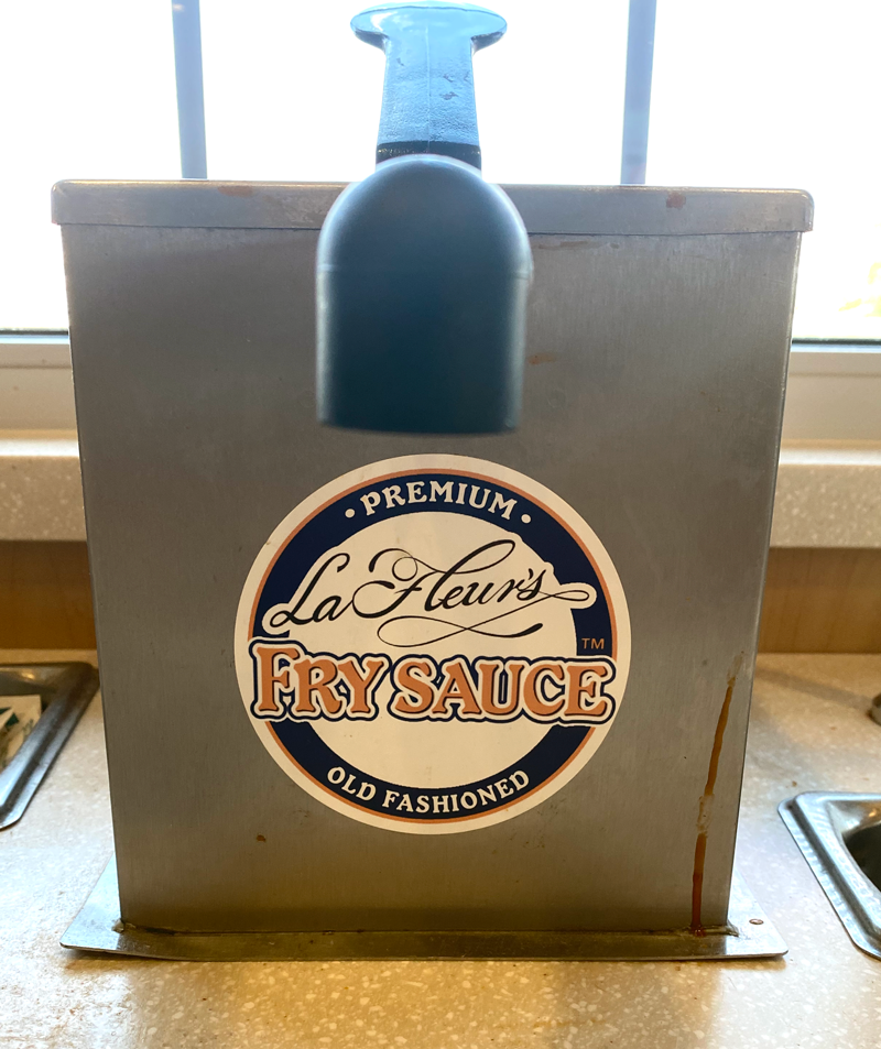 A metal box with a pump and a label that says La Fleur&#x27;s premium, old fashion fry sauce