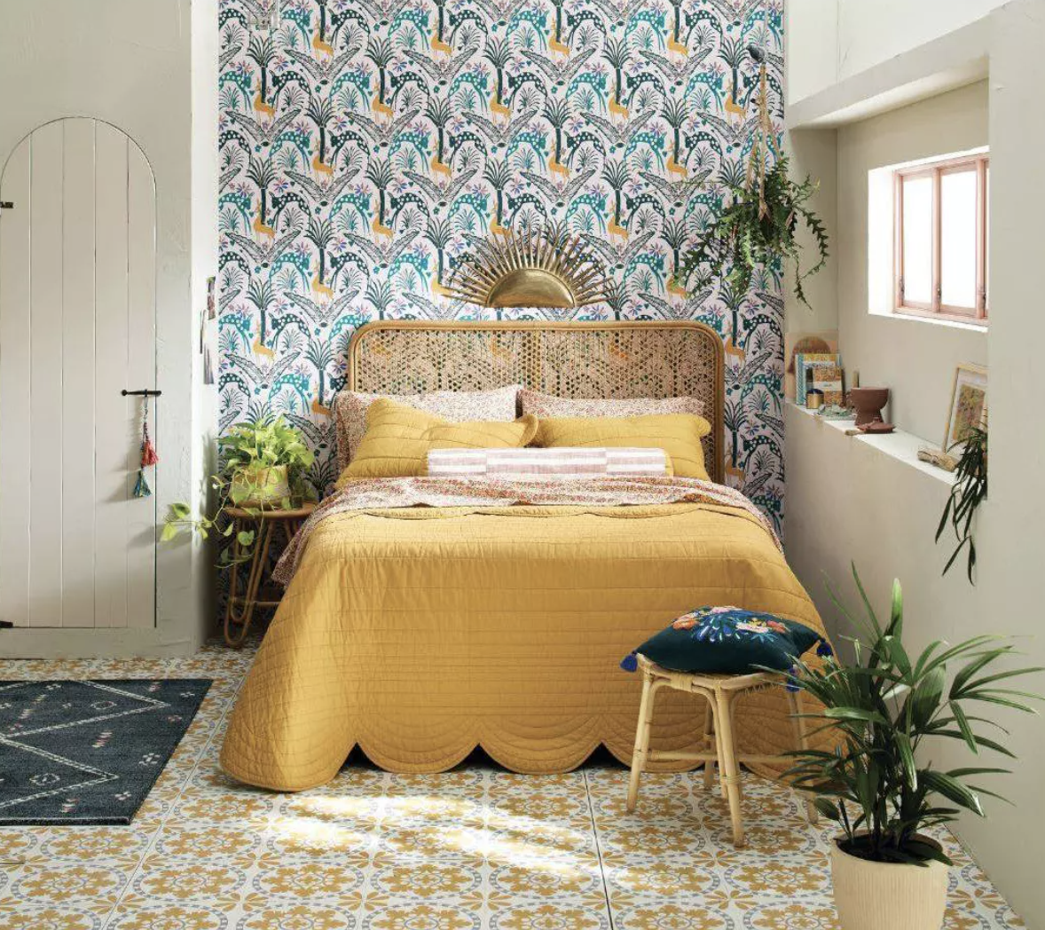 a bed featuring the scalloped quilt in mustard yellow