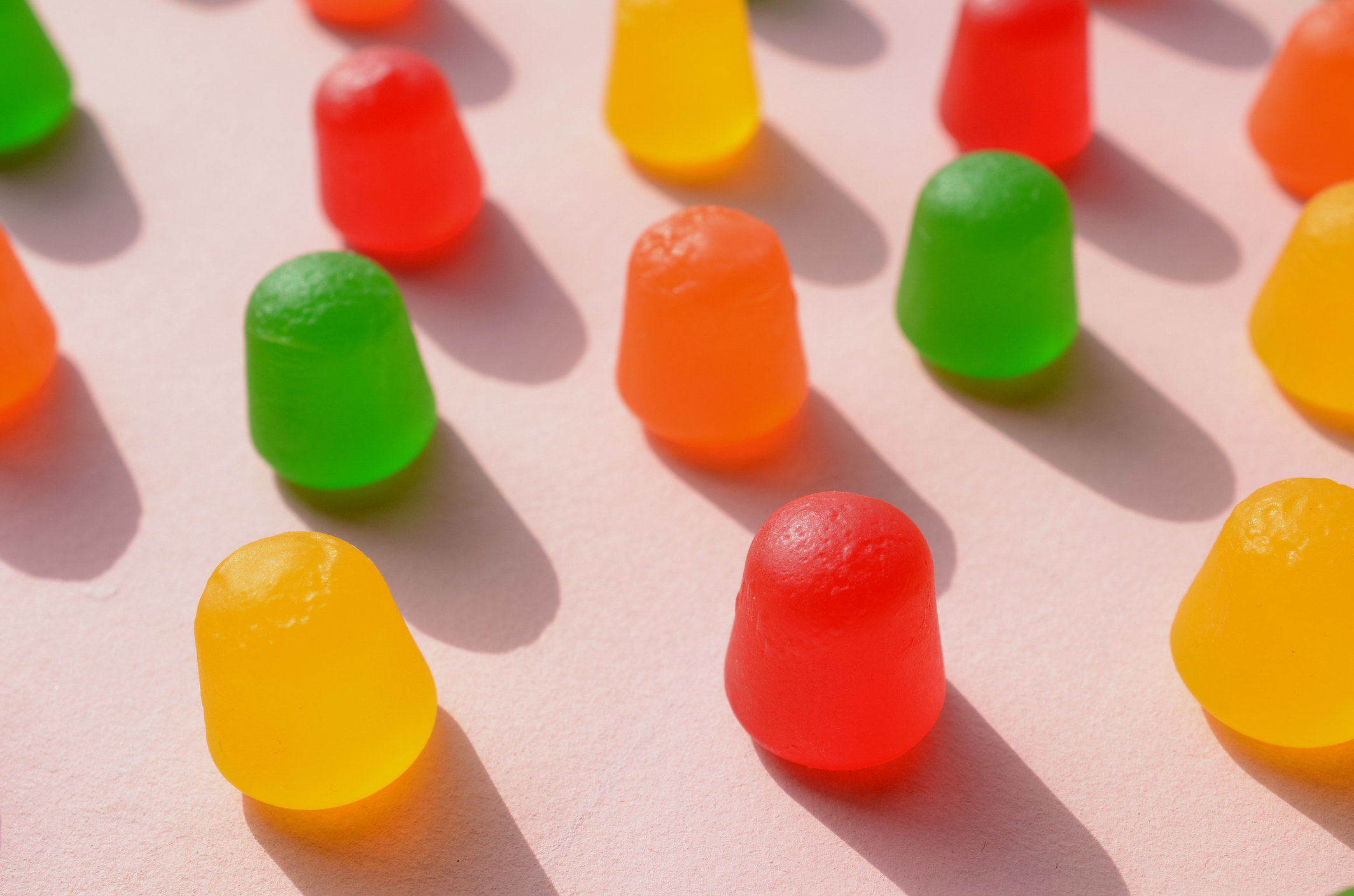 Colorful gumdrops arranged neatly on a solid background