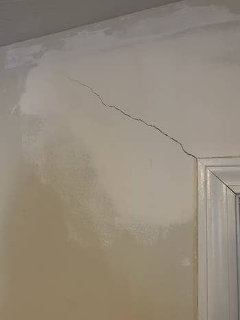 A reviewer photo of a wall with a long crack on it