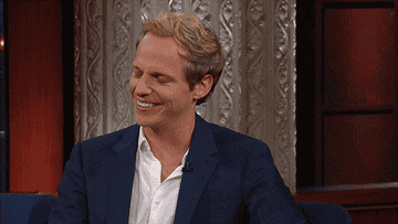 Chris Geere put his hand to his forehead and laughs