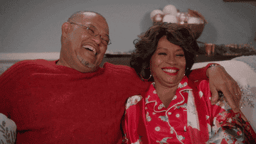 Pops and Ruby Johnson laugh on the couch