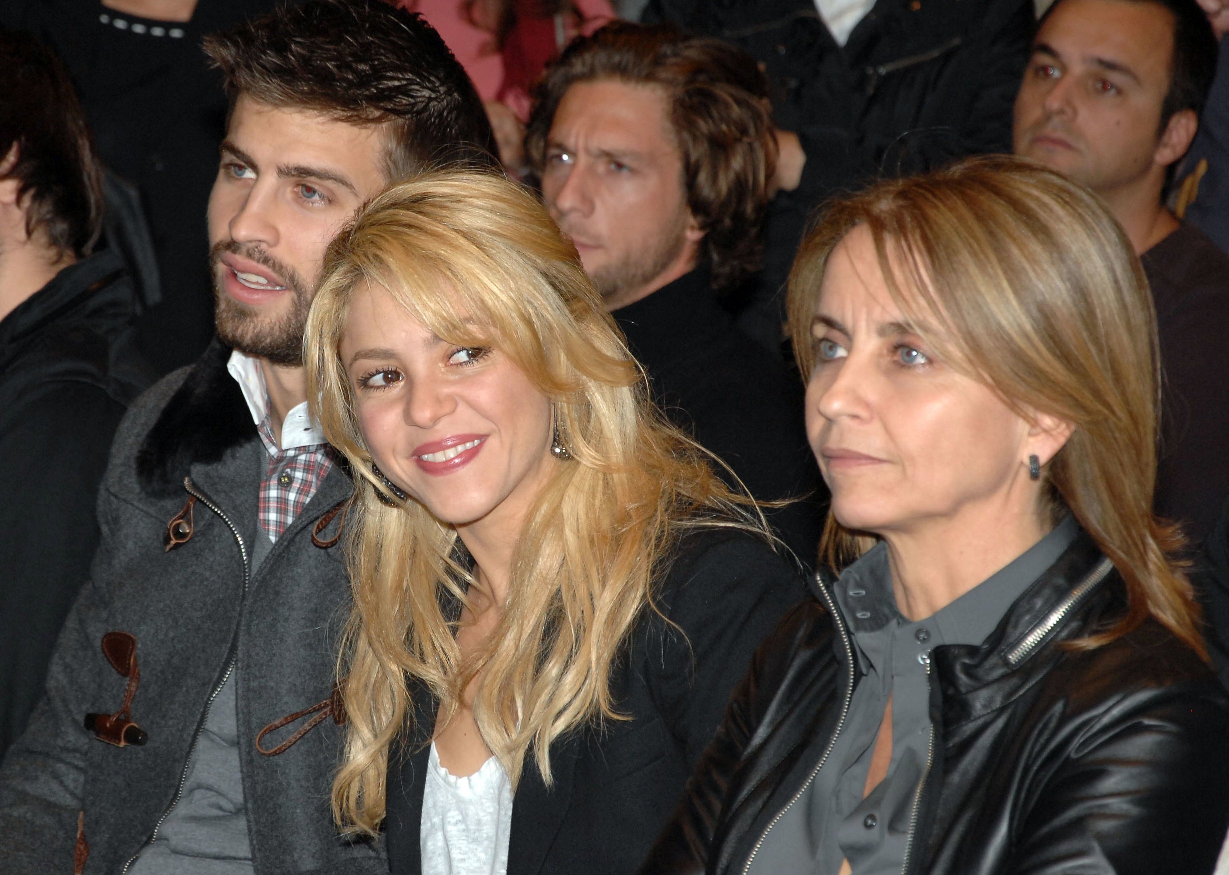 Shakira smiles while sitting next to her mother-in-law at an event