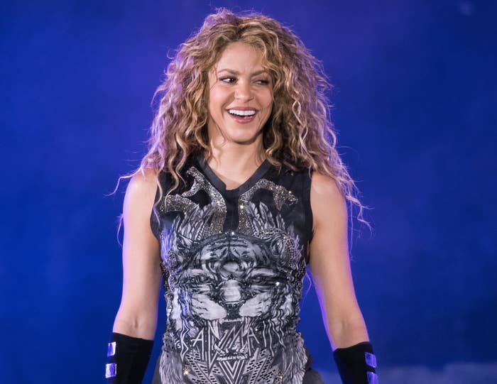 Shakira smiles on stage during a performance