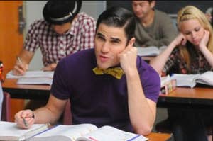 Blaine Anderson singing at desk in class