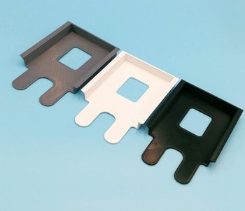 three of the under-desk shelves in gray, white, and black 