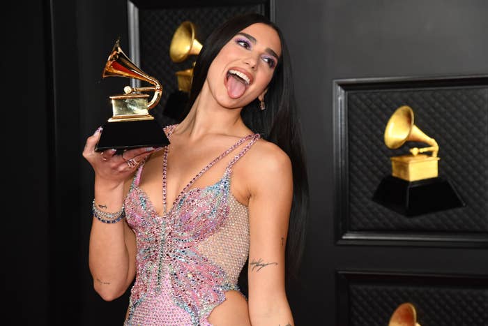 Dua Lipa, winner of Best Pop Vocal Album for &quot;Future Nostalgia,&quot; poses with her tongue out in the media room during the 63rd Annual GRAMMY Awards at Los Angeles Convention Center on March 14, 2021 while wearing a sparkly gown