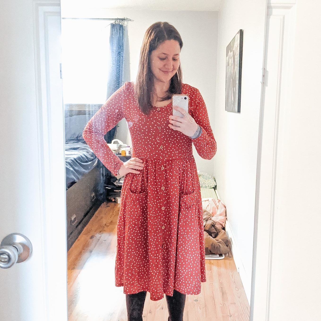 Reviewer wearing button-up polka-dot dress