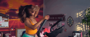 GIF of Ariana Grande on elliptical in &quot;thank u, next&quot; music video