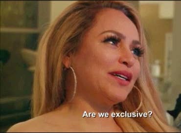 A woman asking a man "Are we exclusive"