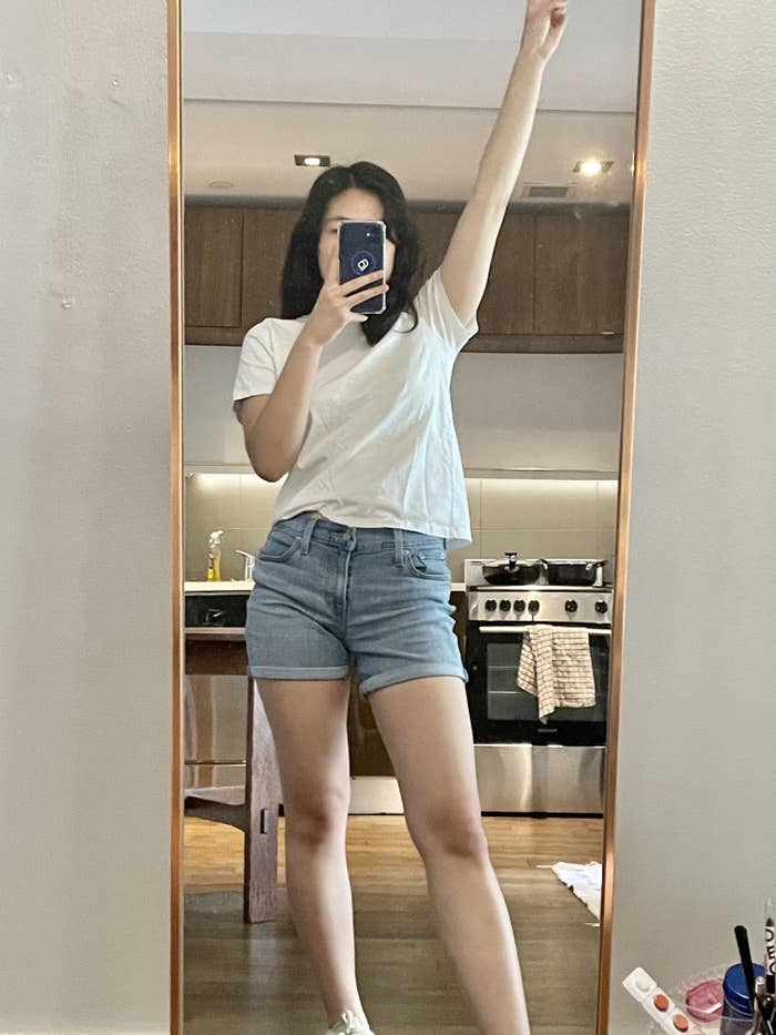 Writer wearing shorts in front of full length mirror