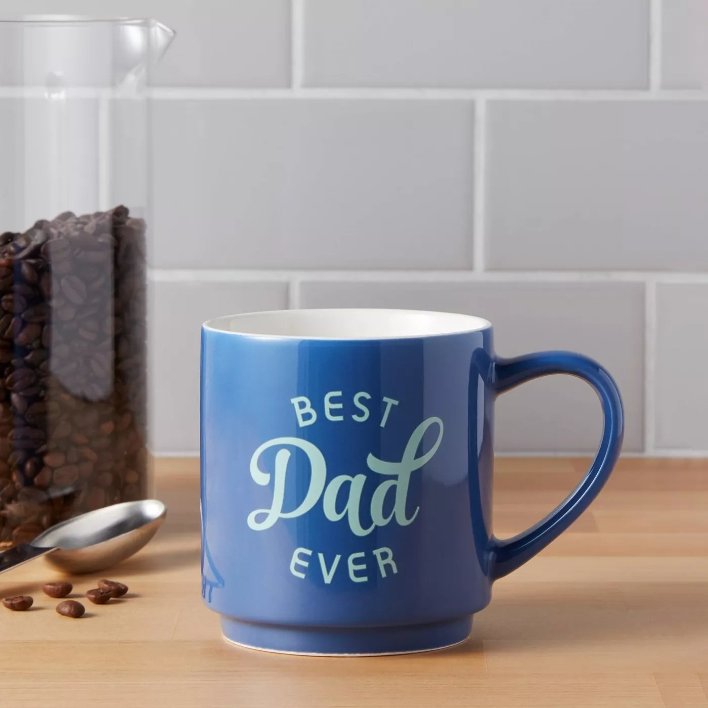 The dark blue mug with &quot;Best Dad Ever&quot; written on the front in light blue on a kitchen counter