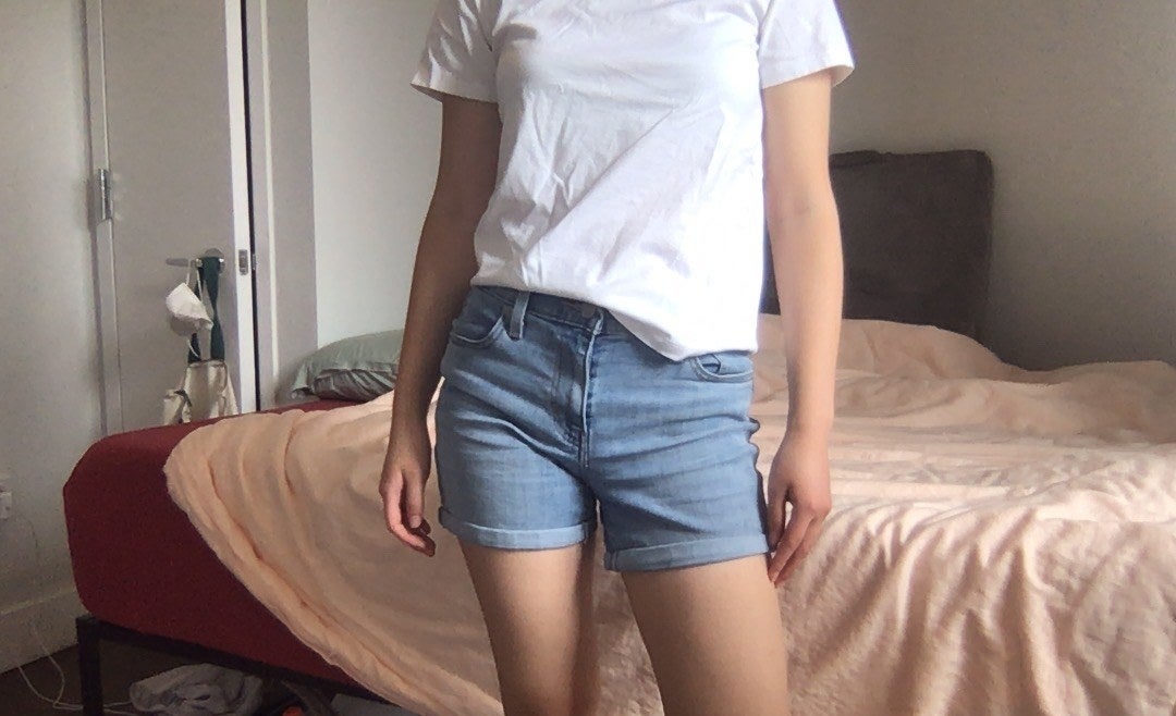 writer photo wearing the shorts standing in bedroom 