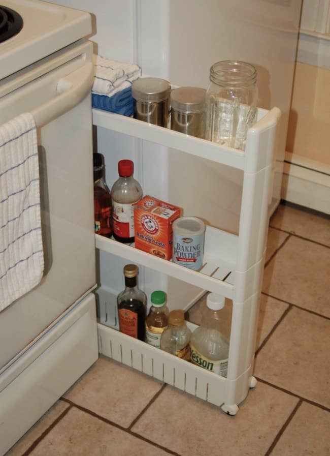 Reviewer's photo of the slide-out storage tower filled with kitchen items
