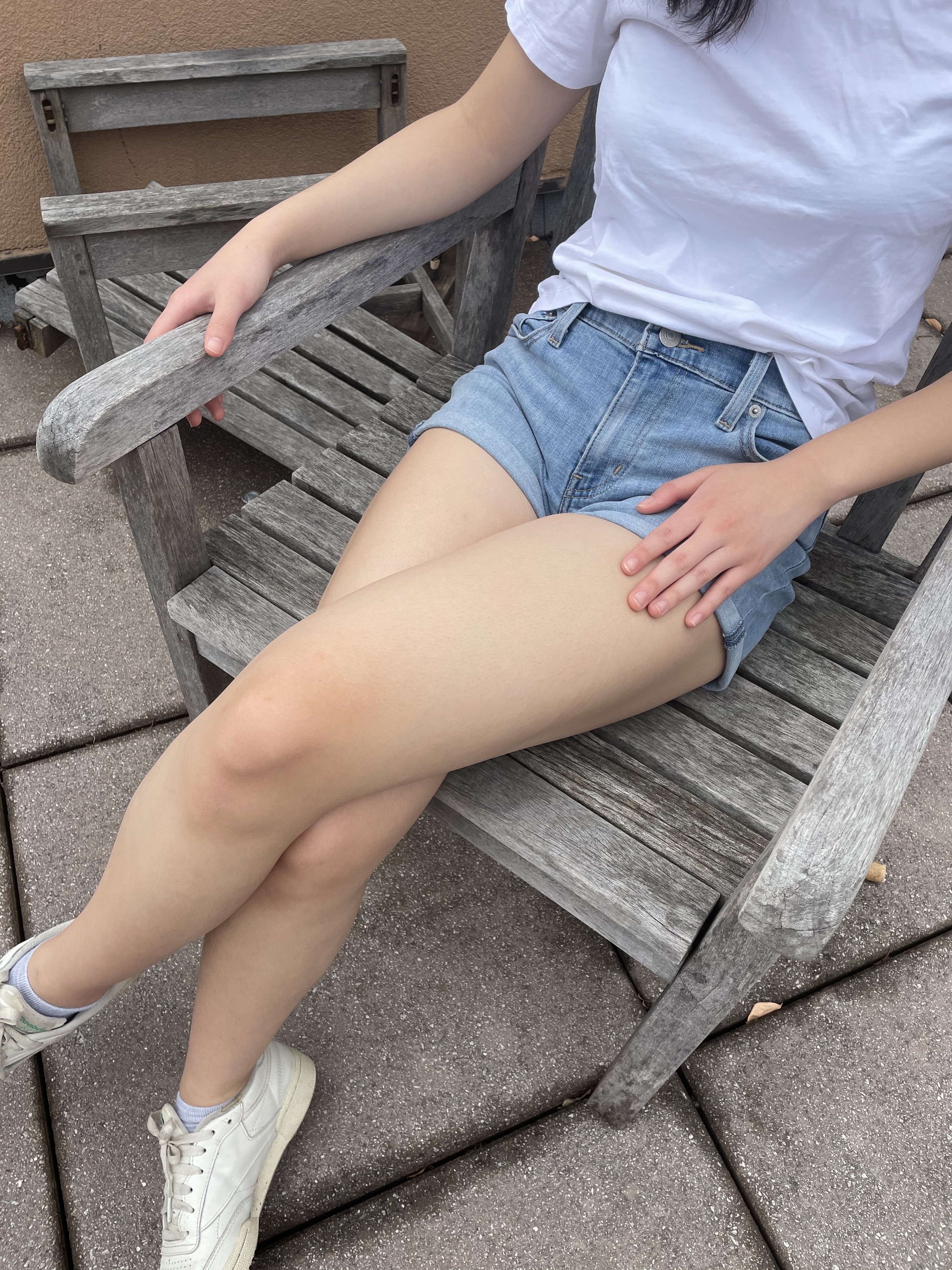 writer photo wearing shorts sitting on a chair outdoors