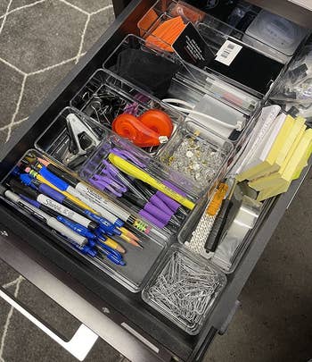 a reviewer photo fo an opened desk drawer filled with office supplies organized in the clear bins