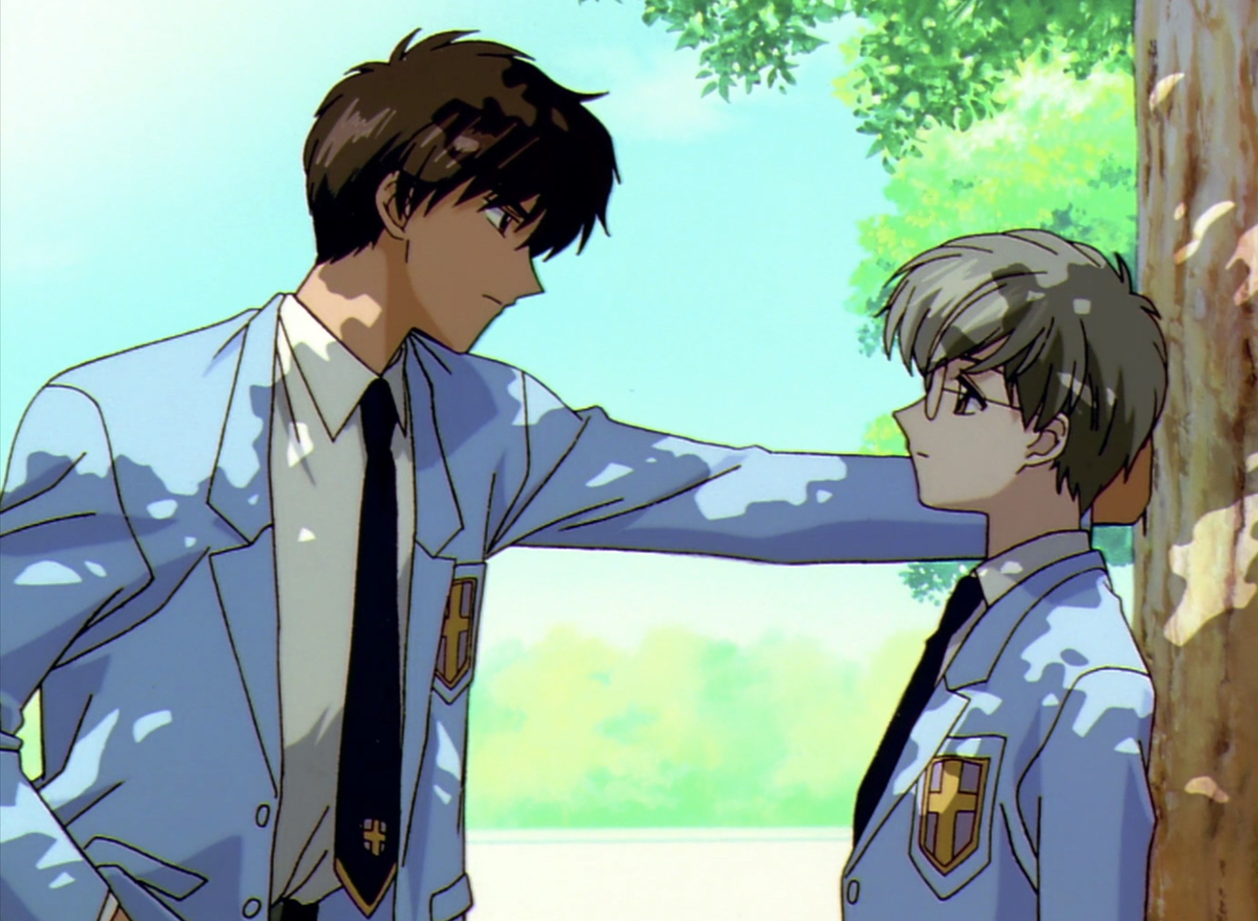 Touya leaning into Yukito as they talk under the trees. crunchyroll.com. 