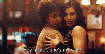 Maureen holding Joanne and saying, &quot;Hey mister, she&#x27;s my sister,&quot; in &quot;Rent&quot;