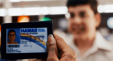 McLovin looks nervously as a clerk checks out his ID