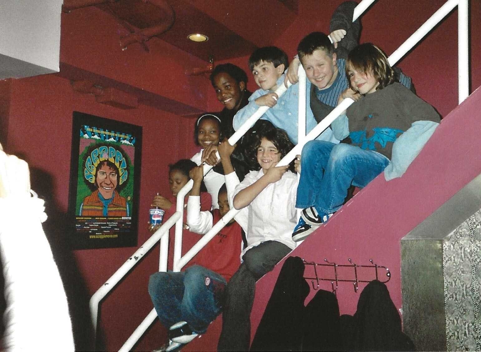 Children pose for a photo on a stairway