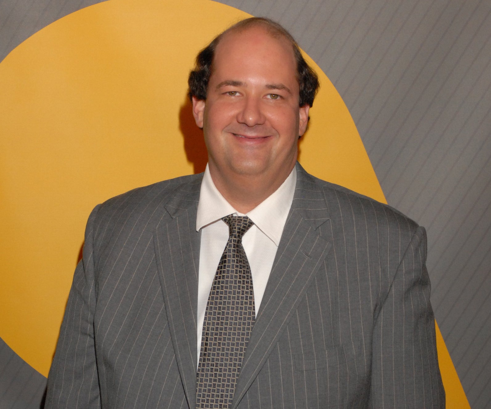 Brian appears at an event in a grey striped suit