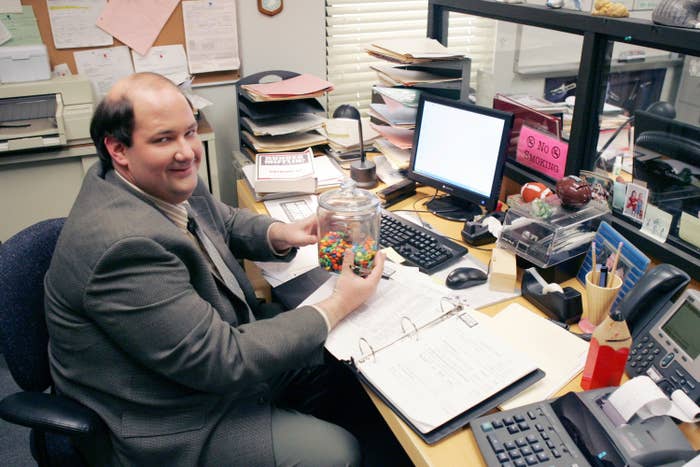 Kevin sits at his desk in a photo from The Office