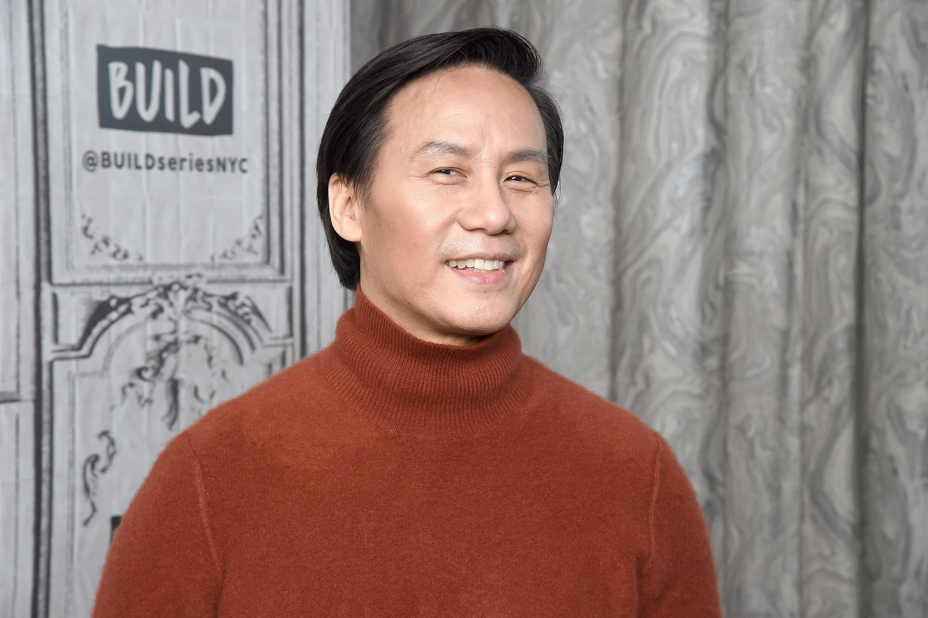 BD Wong, in a turtleneck, smiles for the camera