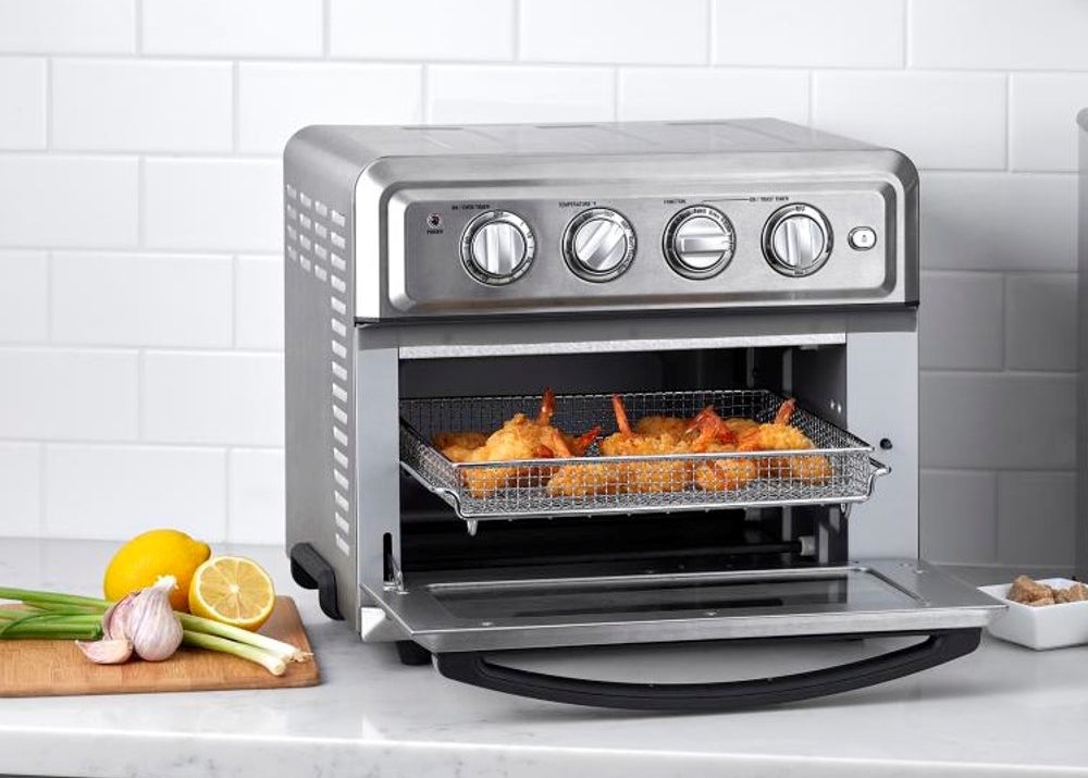silver toaster oven with door open and tray full of fried food