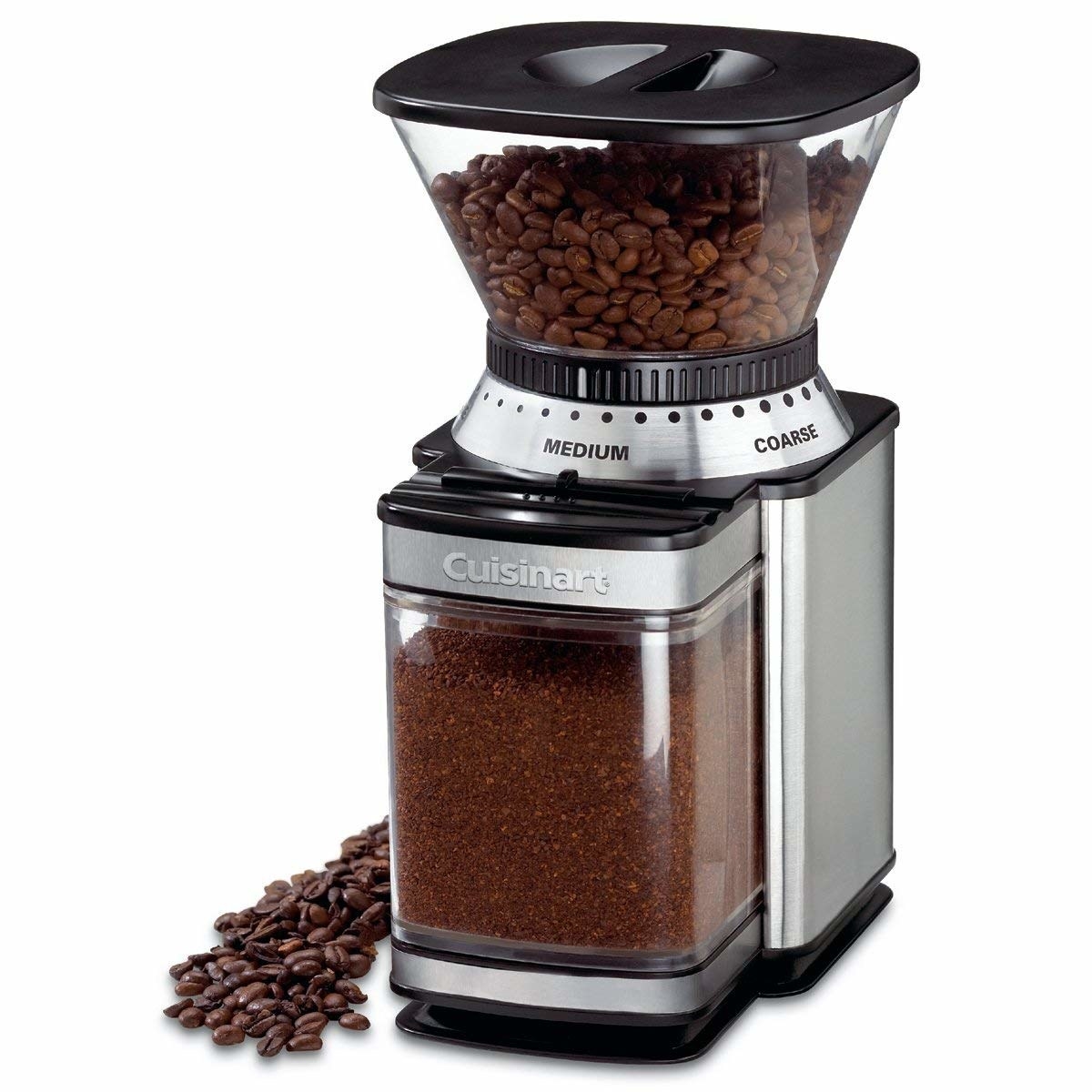 stainless steel coffee grinder with coffee beans on top and grounds underneath