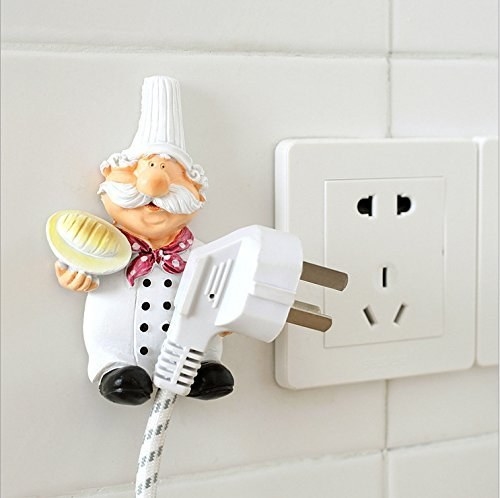 A chef figurine with a plug in his hand next to a socket 