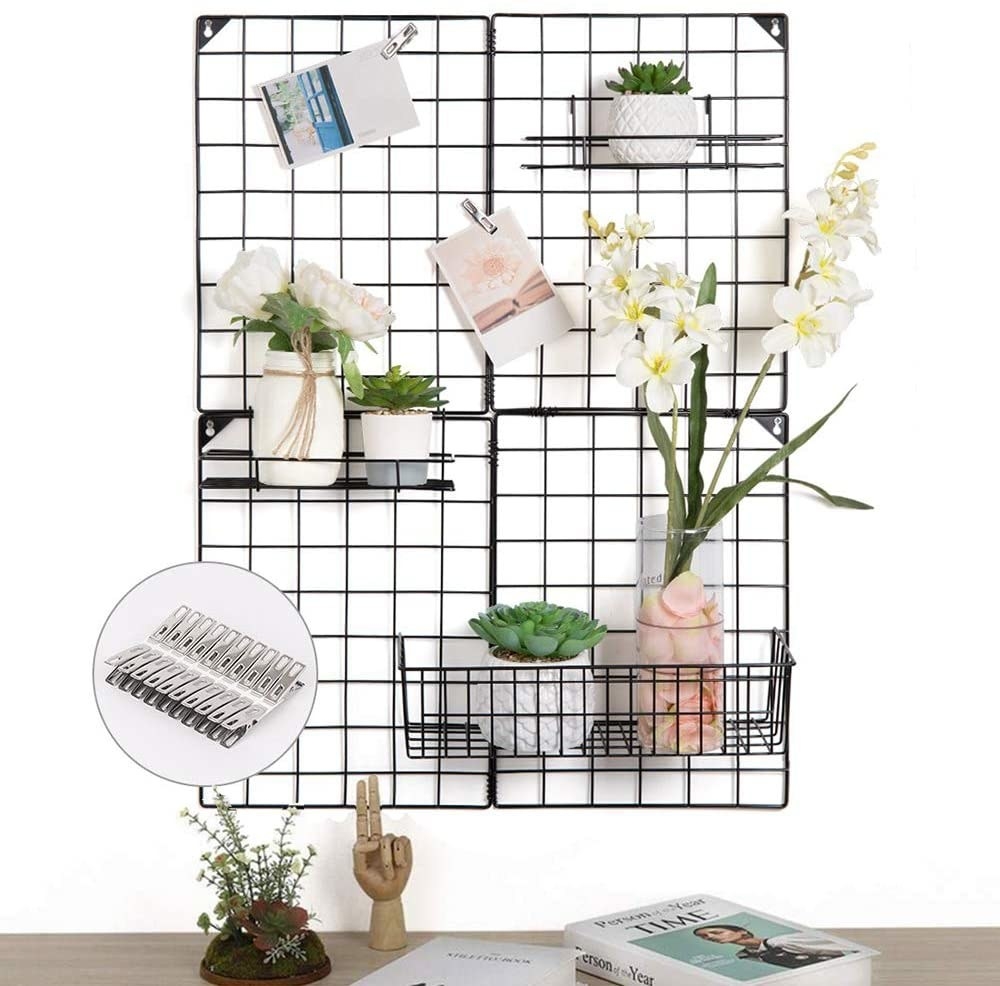Trendy wire grid wall functional decoration with 3 wire baskets; holding photographs and decorative plants.