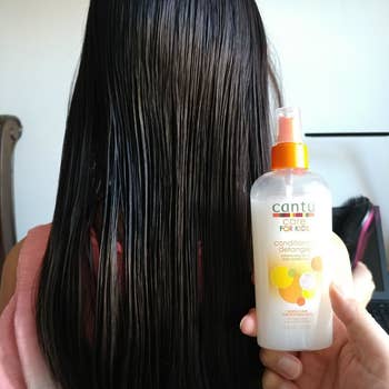 Reviewer's after photo showing smooth hair after using the detangler spray